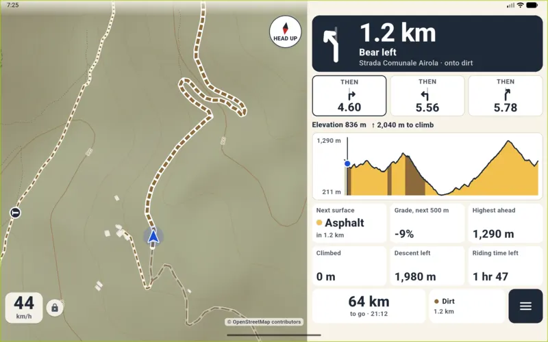 Tablet navigation by day: turn in 1.2 km, roadbook, elevation profile coloured by surface, gradient of the next 500 m.